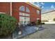 A backyard patio area featuring furniture with mature landscaping, and brick exterior at 6026 Southland Dr, Stone Mountain, GA 30087