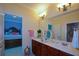 Bright bathroom with double sinks, decorative mirrors, and a view into the bedroom at 6026 Southland Dr, Stone Mountain, GA 30087
