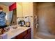 A well-lit bathroom featuring a vanity with framed pictures and decorative towels, and a tub-shower combo at 6026 Southland Dr, Stone Mountain, GA 30087