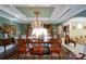 Dining room with designer chandelier, decorative molding, and adjacent living space at 6026 Southland Dr, Stone Mountain, GA 30087