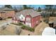 Aerial view of a brick home, featuring mature landscaping, a well-manicured lawn, and a charming neighborhood setting at 6026 Southland Dr, Stone Mountain, GA 30087