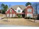 Charming two-story home with a manicured lawn and brick and stucco facade at 6026 Southland Dr, Stone Mountain, GA 30087