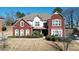 Stunning exterior view of a brick home with manicured landscaping and a well-maintained lawn at 6026 Southland Dr, Stone Mountain, GA 30087