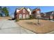 Exterior view of a two-story home with a long driveway at 6026 Southland Dr, Stone Mountain, GA 30087
