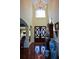 Spacious foyer featuring a grand chandelier, double doors, hardwood floors and architectural details at 6026 Southland Dr, Stone Mountain, GA 30087