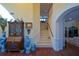 Elegant foyer with a staircase and decorative display cabinet at 6026 Southland Dr, Stone Mountain, GA 30087