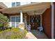 Covered front entrance with stone accents and ornate wood double doors at 6026 Southland Dr, Stone Mountain, GA 30087