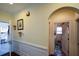 Inviting hallway with wainscoting and neutral paint that leads to additional rooms, with access to a convenient laundry area at 6026 Southland Dr, Stone Mountain, GA 30087