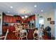 Spacious kitchen features custom wood cabinetry, granite counters, stainless appliances, island, and a chandelier at 6026 Southland Dr, Stone Mountain, GA 30087