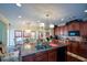 Gourmet kitchen boasts granite counters, wood cabinets, an island, stainless appliances, and is open to the dining area at 6026 Southland Dr, Stone Mountain, GA 30087