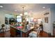 Bright, open kitchen and living area features granite counters, wood cabinetry, an island, and stainless steel appliances at 6026 Southland Dr, Stone Mountain, GA 30087