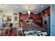 Charming kitchen features granite counters, custom wood cabinetry, stainless appliances, and an island with barstool seating at 6026 Southland Dr, Stone Mountain, GA 30087