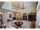 Elegant living room featuring a fireplace, grand chandelier, and staircase to the second level, providing a welcoming ambiance at 6026 Southland Dr, Stone Mountain, GA 30087