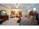 A large main bedroom features a chandelier, a tray ceiling, and detailed curtains at 6026 Southland Dr, Stone Mountain, GA 30087