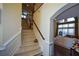 Elegant staircase features neutral carpeting, a wooden handrail, and white trim, offering a grand entrance to the home at 6026 Southland Dr, Stone Mountain, GA 30087