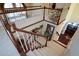 A staircase with carpeting and white banisters overlooks a living area with windows and an upper-level dining area at 6026 Southland Dr, Stone Mountain, GA 30087
