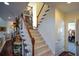 A staircase with carpeted steps and white railings leads to the upper level of this beautiful home at 6026 Southland Dr, Stone Mountain, GA 30087