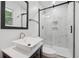 Modern bathroom with walk-in shower, stylish vanity, and black framed mirror at 2005 Simmons Ave, Atlanta, GA 30337