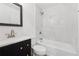 Bathroom with a shower and tub combination with marble-look tile and dark vanity at 2005 Simmons Ave, Atlanta, GA 30337