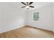 Bedroom with wood-look floors, a ceiling fan, and bright natural light from the window at 2005 Simmons Ave, Atlanta, GA 30337