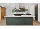 Kitchen with a large island and stainless steel range hood with gray-green cabinetry and white counter-tops at 2005 Simmons Ave, Atlanta, GA 30337