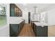 Spacious modern kitchen featuring new cabinets and a stainless steel hood over the island cooktop at 2005 Simmons Ave, Atlanta, GA 30337