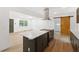 Modern kitchen with stainless steel appliances, white marble counters, and dark green cabinets at 2005 Simmons Ave, Atlanta, GA 30337