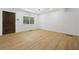 Bright, freshly painted living room features new floors, trim, and a new ceiling fan with lighting at 2005 Simmons Ave, Atlanta, GA 30337