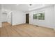 Living room featuring new floors, fresh paint, and a doorway leading to the hallway at 2005 Simmons Ave, Atlanta, GA 30337
