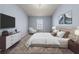 Relaxing bedroom with a large window, stylish decor, a TV, and a comfortable seating area at 5170 Black Bear Trl, Douglasville, GA 30135