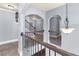 Upstairs hallway with wrought iron railing and decorative lighting at 5170 Black Bear Trl, Douglasville, GA 30135