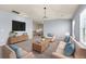 Open living room features neutral tones, plush carpet, stylish furniture, and an abundance of natural light at 5170 Black Bear Trl, Douglasville, GA 30135