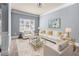 Inviting living room featuring white leather furniture, glass tables, and natural light at 5170 Black Bear Trl, Douglasville, GA 30135