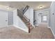 Carpeted staircase with wooden railing leading to the upper level of the house at 5170 Black Bear Trl, Douglasville, GA 30135