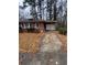 Charming brick home exterior with covered parking, solar panels, and mature trees at 3518 Hamlin Cir, Atlanta, GA 30341