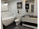 Modern bathroom featuring a soaking tub and sleek vanity with black countertop at 361 17Th Nw St # 2423, Atlanta, GA 30363