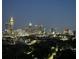 Panoramic nighttime city view highlighting illuminated buildings and lush greenery at 361 17Th Nw St # 2423, Atlanta, GA 30363