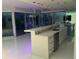 Contemporary kitchen with waterfall countertops, stainless steel appliances, and sliding glass doors to a private balcony at 361 17Th Nw St # 2423, Atlanta, GA 30363