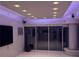 Modern living room with recessed lighting and floor to ceiling sliding glass doors showcasing expansive city views at 361 17Th Nw St # 2423, Atlanta, GA 30363