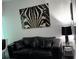 Stylish living room featuring a black leather sofa and striking zebra art piece at 361 17Th Nw St # 2423, Atlanta, GA 30363