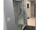 Walk in shower with elegant marble-like tile and glass doors at 361 17Th Nw St # 2423, Atlanta, GA 30363