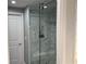 Walk in shower with elegant marble-like tile and glass doors at 361 17Th Nw St # 2423, Atlanta, GA 30363