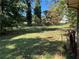 A very overgrown backyard featuring grass and lots of trees at 5581 Shadow Rock Dr, Lithonia, GA 30058