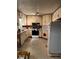 Outdated kitchen area with beige cabinets, appliances, and outdated flooring at 5581 Shadow Rock Dr, Lithonia, GA 30058