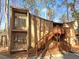 Two-story condo with wood exterior and charming staircases to the second level entry at 5780 Par Four Ct, Lithonia, GA 30038