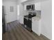 Spacious kitchen with stainless steel appliances, white cabinets, and new flooring at 5780 Par Four Ct, Lithonia, GA 30038