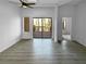 Open-concept living room with sleek floors, ceiling fan, and a sliding glass door leading to the deck at 5780 Par Four Ct, Lithonia, GA 30038