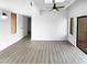 Living room featuring vinyl floors, light walls, modern fixtures, and a sliding glass door at 5780 Par Four Ct, Lithonia, GA 30038