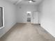 Main bedroom with light walls, neutral carpet, and a door to an ensuite bathroom at 5780 Par Four Ct, Lithonia, GA 30038