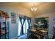 Well-lit dining room with table set for dinner, chandelier, and see-through display cabinet at 1660 Almand Creek Sw Dr, Conyers, GA 30094